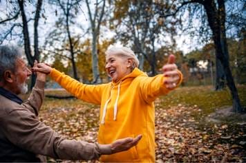 House of Hearing Aids Moab UT - An older couple dancing in the park.
